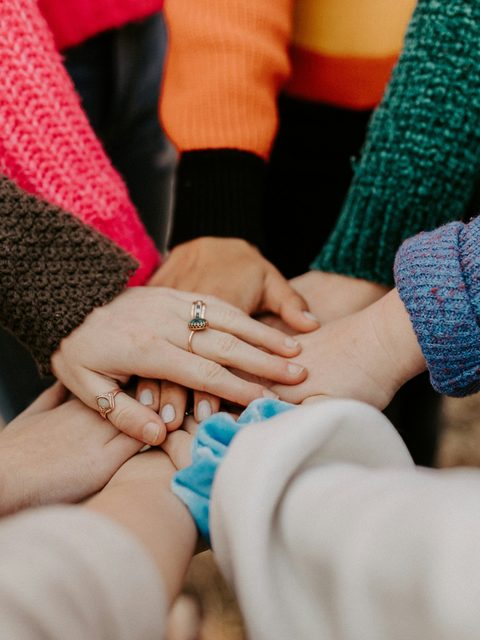 Hands stacked together in a circle