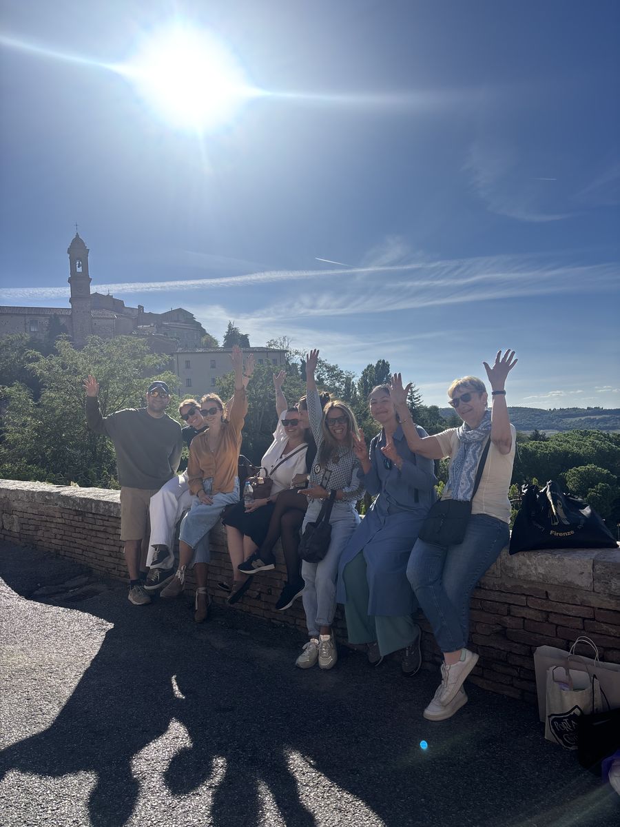 The retreat group waving from a sunny hilltop terrace
